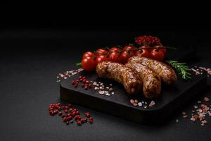 Delicious fried grilled sausages with salt, spices and herbs photo