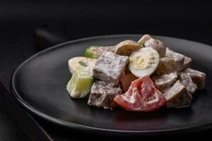 Delicious salad with boiled beef tongue, quail eggs, tomatoes and cucumber photo