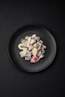 Delicious salad with boiled beef tongue, quail eggs, tomatoes and cucumber photo