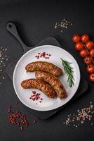 Delicious fried grilled sausages with salt, spices and herbs photo