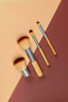 Set of makeup brushes with bamboo handles. Professional brushes collection, arranged in a beautiful line. Natural make up tools photo
