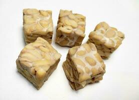 Raw Tempeh, dice cutting, On White Background. photo