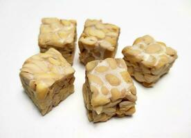 Raw Tempeh, dice cutting, On White Background. photo