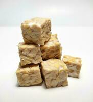 Pile of raw tempeh, dice cutting, On White Background. photo