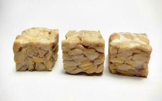 Raw Tempeh, dice cutting, On White Background. photo