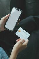 Close up of woman hand using credit card and laptop for payment and online shopping, Online shopping, payments digital banking, E-commerce concept. photo