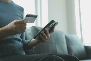 Close up of woman hand using credit card and laptop for payment and online shopping, Online shopping, payments digital banking, E-commerce concept. photo