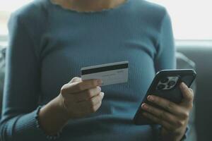 Close up of woman hand using credit card and laptop for payment and online shopping, Online shopping, payments digital banking, E-commerce concept. photo