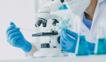 microscope with lab glassware, science laboratory research and development concept photo