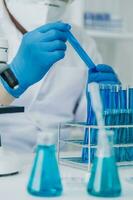 microscope with lab glassware, science laboratory research and development concept photo