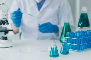 microscope with lab glassware, science laboratory research and development concept photo