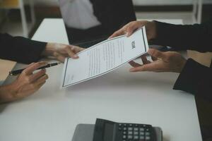 Close up view of job interview in office, focus on resume writing tips, employer reviewing good cv of prepared skilled applicant, recruiter considering application, hr manager making hiring decision photo