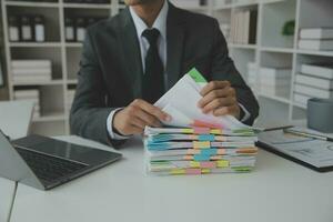 Group of confident business people point to graphs and charts to analyze market data, balance sheet, account, net profit to plan new sales strategies to increase production capacity. photo