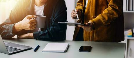 Close up ux developer and ui designer brainstorming about mobile app interface wireframe design on table with customer breif and color code at modern office.Creative digital development agency photo