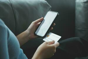 Close up of woman hand using credit card and laptop for payment and online shopping, Online shopping, payments digital banking, E-commerce concept. photo