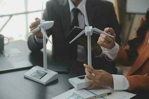 Group of confident business people point to graphs and charts to analyze market data, balance sheet, account, net profit to plan new sales strategies to increase production capacity. photo