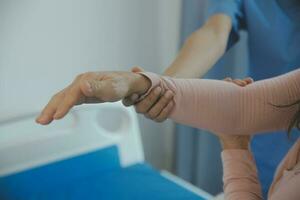 Doctor or physical therapist examines back pain and spinal area to give advice within the rehabilitation center. photo