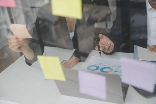 Financial analysts analyze business financial reports on a digital tablet planning investment project during a discussion at a meeting of corporate showing the results of their successful teamwork. photo