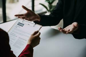 Close up view of job interview in office, focus on resume writing tips, employer reviewing good cv of prepared skilled applicant, recruiter considering application, hr manager making hiring decision photo