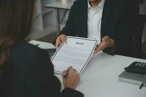 Close up view of job interview in office, focus on resume writing tips, employer reviewing good cv of prepared skilled applicant, recruiter considering application, hr manager making hiring decision photo