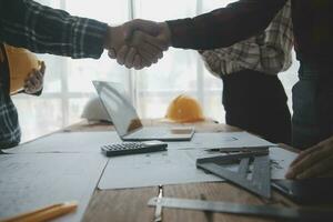 Two business man construction site engineer. Engineering objects on workplace with partners interacting on background photo