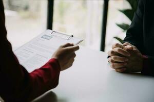 Close up view of job interview in office, focus on resume writing tips, employer reviewing good cv of prepared skilled applicant, recruiter considering application, hr manager making hiring decision photo