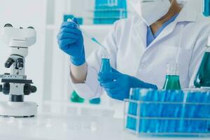 microscope with lab glassware, science laboratory research and development concept photo