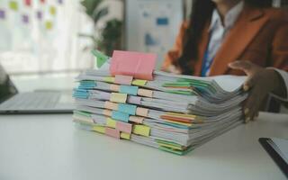 Group of confident business people point to graphs and charts to analyze market data, balance sheet, account, net profit to plan new sales strategies to increase production capacity. photo