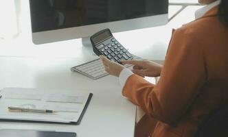 Group of confident business people point to graphs and charts to analyze market data, balance sheet, account, net profit to plan new sales strategies to increase production capacity. photo