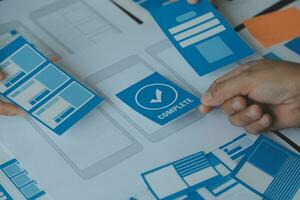 ux Graphic designer creative sketch planning application process development prototype wireframe for web mobile phone . User experience concept. photo