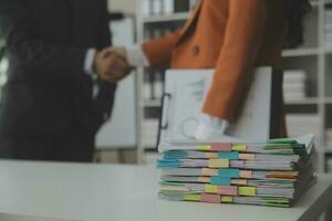 Group of confident business people point to graphs and charts to analyze market data, balance sheet, account, net profit to plan new sales strategies to increase production capacity. photo
