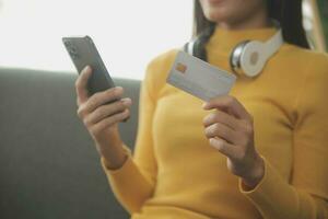 Close up of woman hand using credit card and laptop for payment and online shopping, Online shopping, payments digital banking, E-commerce concept. photo