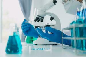microscope with lab glassware, science laboratory research and development concept photo