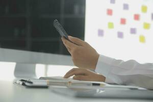 Group of confident business people point to graphs and charts to analyze market data, balance sheet, account, net profit to plan new sales strategies to increase production capacity. photo