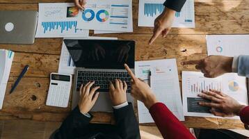 Financial analysts analyze business financial reports on a digital tablet planning investment project during a discussion at a meeting of corporate showing the results of their successful teamwork. photo