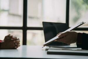 Close up view of job interview in office, focus on resume writing tips, employer reviewing good cv of prepared skilled applicant, recruiter considering application, hr manager making hiring decision photo