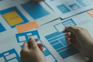 ux Graphic designer creative sketch planning application process development prototype wireframe for web mobile phone . User experience concept. photo