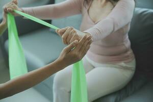 Doctor or physical therapist examines back pain and spinal area to give advice within the rehabilitation center. photo