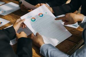 Brainstorming Collaboration and successful partnership analysis by Young business Asian people working in an office workspace photo