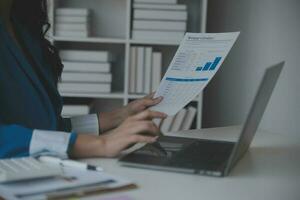 Financial analysts analyze business financial reports on a digital tablet planning investment project during a discussion at a meeting of corporate showing the results of their successful teamwork. photo