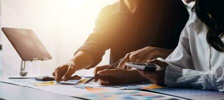 Close up ux developer and ui designer brainstorming about mobile app interface wireframe design on table with customer breif and color code at modern office.Creative digital development agency photo
