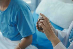 Injured patient showing doctor broken wrist and arm with bandage in hospital office or emergency room. Sprain, stress fracture or repetitive strain injury in hand. Nurse helping customer. First aid. photo