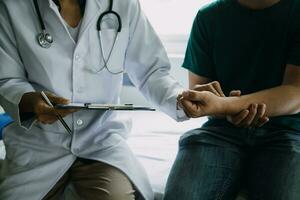 Male patient having consultation with doctor or psychiatrist who working on diagnostic examination on men's health disease or mental illness in medical clinic or hospital mental health service center photo