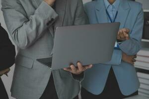 Financial analysts analyze business financial reports on a digital tablet planning investment project during a discussion at a meeting of corporate showing the results of their successful teamwork. photo