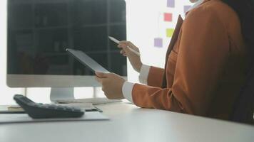 Group of confident business people point to graphs and charts to analyze market data, balance sheet, account, net profit to plan new sales strategies to increase production capacity. photo