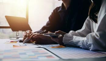 Close up ux developer and ui designer brainstorming about mobile app interface wireframe design on table with customer breif and color code at modern office.Creative digital development agency photo