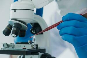 microscope with lab glassware, science laboratory research and development concept photo