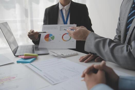 Financial analysts analyze business financial reports on a digital tablet planning investment project during a discussion at a meeting of corporate showing the results of their successful teamwork. photo
