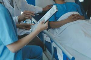 Injured patient showing doctor broken wrist and arm with bandage in hospital office or emergency room. Sprain, stress fracture or repetitive strain injury in hand. Nurse helping customer. First aid. photo