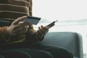 Close up of woman hand using credit card and laptop for payment and online shopping, Online shopping, payments digital banking, E-commerce concept. photo